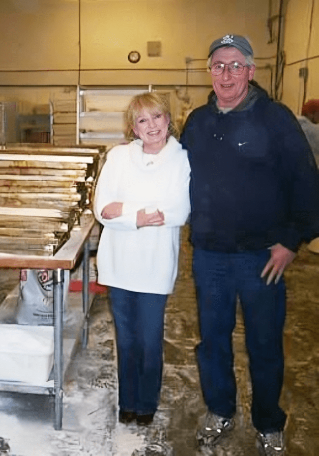Two people smiling in a bakery